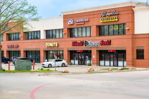 Exterior view of the commercial building housing All Smiles Dentistry on Bethany Drive in Allen, Texas.