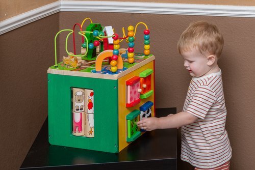 Small child playing with a toy in the dental waiting room