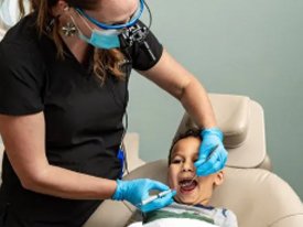 Dentist in Allen doing a dental exam on a child