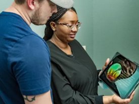 Dental hygienist educating her patient about gum disease