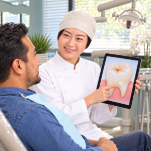 Dentist explains early cavity warning signs on an iPad to a patient at All Smiles Dentistry in Allen.